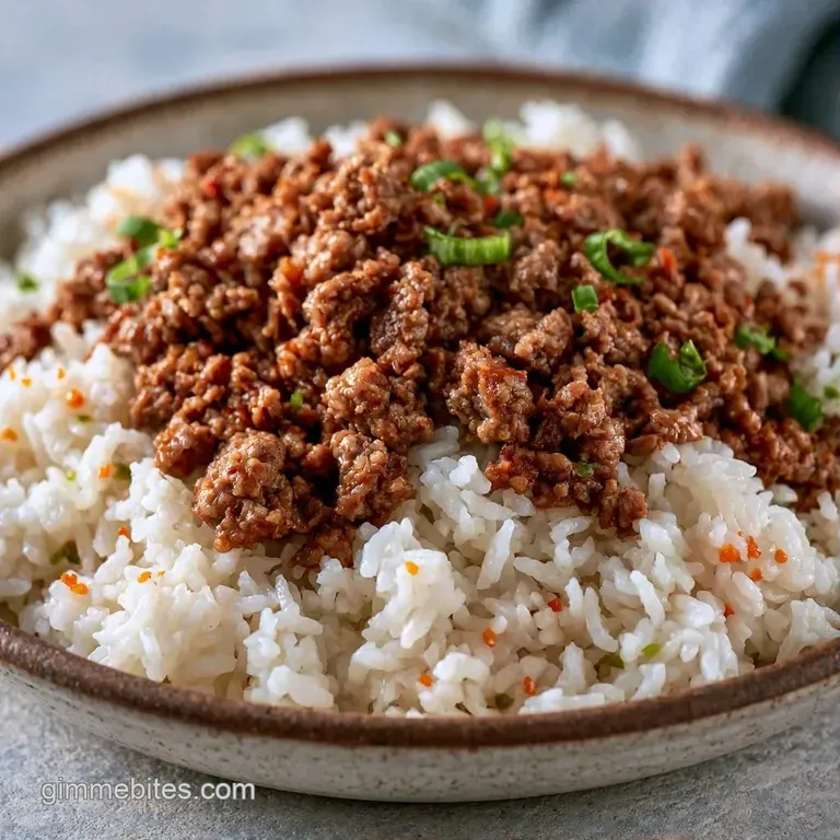 Hearty beef and vegetable mix served in a cast-iron pan with a side of fluffy white rice and a sprig of fresh cilantro.
