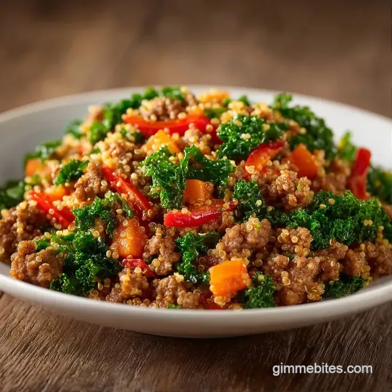 A clean portion of browned beef and bright vegetables centered on a white plate with a garnish of green herbs.