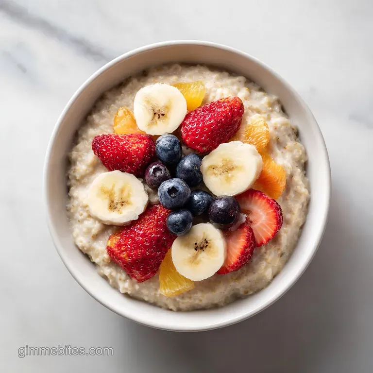 Elegant bowl of warm oatmeal artfully arranged with colorful fruit slices and a drizzle of honey, ready to eat.