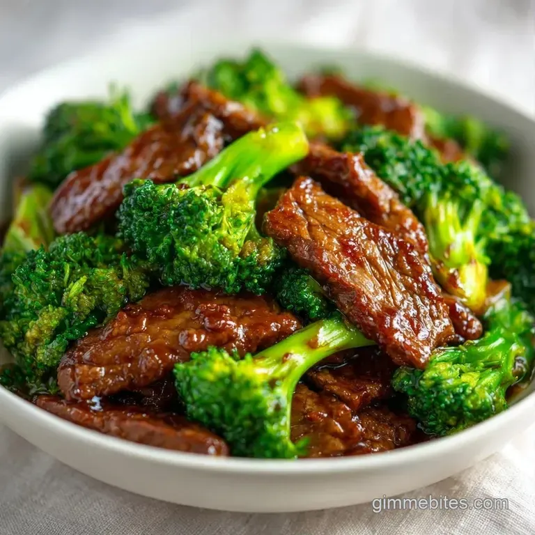 Tender beef slices and crisp colorful vegetables arranged neatly atop a bed of fluffy white steamed jasmine rice.